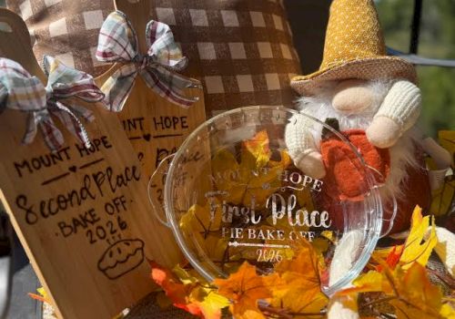 A fall-themed contest display with &ldquo;Animal Place Pie Bake&rdquo; in a glass pie plate and a &ldquo;Second Place&rdquo; sign, with a scarecrow figure.